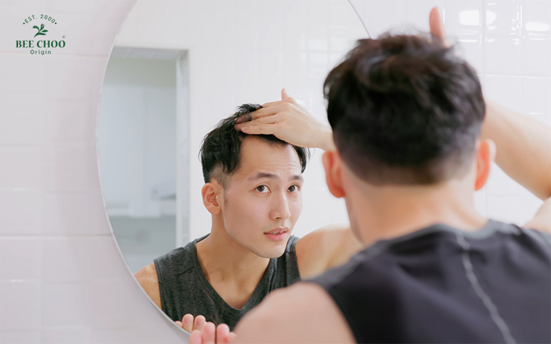 A man worried about his receding hairline
