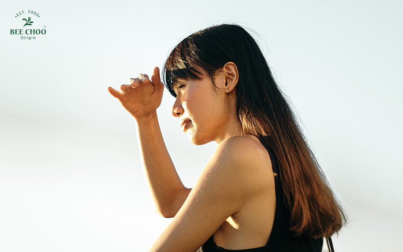 Woman squinting in the sun, possibly due to hair damage.