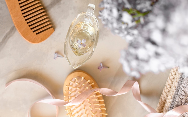 Natural oils and wooden combs supporting hair care
